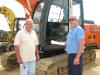 Dale Hollis (L) of Dale Hollis Farms in Sulligent, Ala., and Toby Patrick of T&T Dirt in Vernon, Ala., look over a Hitachi Zaxis 120 excavator.