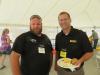 Enjoying the barbecue lunch at the grand opening are Kris Jones (L) of North Central Kansas Technical College and Jon Robinson of Foley Industries.
