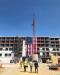 The AC Hotel construction prominently displays a massive American flag.