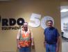 Jerrod Rudnitski (L), Ames Construction equipment manager, Burnsville, Minn., and Ames President Raymond Ames pose with the autographed RDO sign.