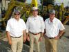 (L-R): Joey Martin, owner of Joey Martin Auctioneers; Mark Long, Southland Machinery, Leeds, Ala.; and Tom Powell, also of Joey Martin Auctioneers, talk about the rental machines consigned to the sale by Southland. 
