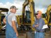 Jim Bennett (L), retired contractor from Picayune, Miss., and Herb Haddox, Haddox Blueberry Farm, Sumrall, Miss., discuss the lineup of machines in the sale.