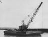 A crane on top of a pontoon is being used to dredge the lagoon in August 1943.
(U.S. Navy Seabee Museum photo)