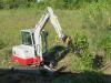 Andy Mulder, owner of Mulder Maintenance and Services, clears brush at McCann Industries’ new Merrillville, Ind., location using a Takeuchi TB240 mini-excavator equipped with an ENGCON EC204 with a RF quick coupler and also equipped with joystick steering.
