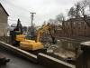 A hammer and loader are demolishing a concrete foundation to prepare for construction of a new drainage system for the downtown rail corridor.