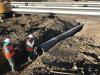 A section of a newly-installed storm water pipe is being inspected.
