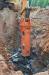 An NPK GH-12 hydraulic breaker utilizes a SANY carrier machines and chips away at rock for pipe installation.
