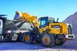A Longhorn Construction Services operator loads a truck with a Komatsu WA270-8 wheel loader.
