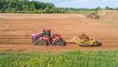 A tractor and scraper strip topsoil at Hamilton Walk, Lehigh County, Pa.