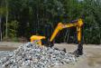 Canyon Springs Landscaping’s JCB model 48Z excavator tackles a pile of decorative stone.