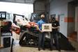 U.S. Army veteran Andrew Long received a framed photograph featuring his new machine and all 45 of the Doosan Bobcat employees who had a hand in assembling it, along with their signatures.
