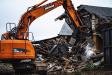 The reduced-tail-swing Doosan excavator was key in removing the dirt and debris. 
