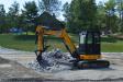 Canyon Springs’ JCB 48Z mini-excavator manipulates a stone pile while on the site of an indoor horse-riding arena in southern Maine.