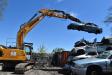 The Liebherr R922 excavator gives this package the reach and strength to easily pick up an automobile from a pile and place it into position for recycling.