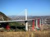 Enormous red steel towers were erected as temporary support piers between the concrete piers of the Millau Viaduct.