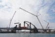 Forty steel segments of its infinity arch, ranging in weight up to 143 tons, needed to be installed over the Dubai creek and above the bridge deck, which could not support a suitably sized crane. 