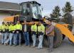 Mike Lutz (far R) poses for a photo with Paul Nice (fifth from L), highway superintendent of Franconia Township, and the crew.