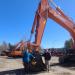 Corey and Brad Chappell pose with a Hitachi ZX490, one of the first of many excavators they will take possession of as the new Hitachi dealer for Massachusetts, Vermont and New Hampshire.