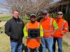 Thomas Jones (L), R.K. Hall’s Amarillo operations manager, accepts an award with  members of the R.K. Hall team for work on a 4.76-mi. section of U.S. 60 in Carson County from County Road W east of Panhandle to County Road W west of White Deer. This section consisted of cement treating the base and placing down a 28,000-ton, 2-in. layer of hot mix.