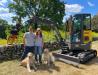 Tylan and Jennifer (and their dogs, Ralph and Daisy) with their new ECR25 Electric compact excavator.