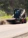 Donald Phillips of the town of Parishville highway department brooms a road.
