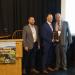 (L-R): Nick Padulo and Brendan Geiss, both of Tracey Road Equipment, receive the 2022 VISION award from Incoming Association President David Miller of the town of Lockport.(Photo courtesy of New York State Association of Town Superintendents of Highways.)