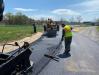 The highway crew paves a roadway at the Recreation Park.
