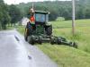 Nate Harrigan of the town of Chateaugay highway department performs roadside mowing along a town road.