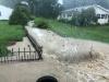 Crews enlarge a creek after multiple flooding events.