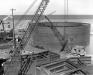 On Aug. 31, 1954, the caisson for the north main tower foundation is afloat at Wiltse Brothers Shipyard near Alpena.