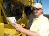 Tim Thomas of Tractor & Equipment Company, Birmingham, Ala., jots down a couple of notes on a Komatsu WA450 wheel loader. 