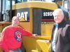 Doug Reed (L) Silver Creek Supply, Kenton, Ohio, talks with the top bidder on this Caterpillar 928Gz loader, Rodney Hensel of Hensel Ready Mix, Kenton, Ohio. 