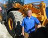 Ed Harseim of Hyundai poses with an HL 770-9A wheel loader at the event. 
