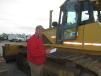 Mike Loecke of Loecke Auction Services takes note of this John Deere 750J.
 