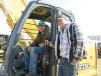 Zachery Ables (L) of Ables Drywal and Bobby Oliver of Oliver Excavating inspect this John Deere 225C LC excavator. 
 