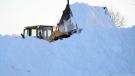 Emily Paine/The Morning Call photo
A front-end loader piles snow in a shopping center parking lot in Whitehall, Pa. 