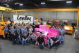 The LeeBoy team that built the pink paver shows their pride by coloring the logos on their hats pink. 