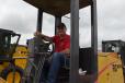 Larry Miller of Klebe Brothers Equipment in Milwaukee, Wis., sits at the controls of a New Holland motorgrader.
 