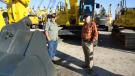 Ronnie Benning (L) and Perry Boyd of Boyd Utility Boring came to the auction looking for an excavator — and there were many to choose from.