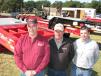 Ready to talk to auction attendees about the lineup of Talbert Trailers at the Lucky’s Truck & Trailer Sales display area (L-R) are Lucky Dimmick, Russ Losh and Jeff Barry. 