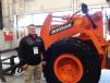 Marc Olson of Doosan Infracore International, West Fargo, N.D., shows off the new Doosan DL 220-5 wheel loader.