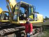 Larry Hilton of AIS Construction Equipment Corp. looks over this Komatsu PC390LC excavator.

