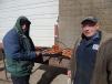Sammy Melcher (L) and Rich Braunwarth, Lano service technician, cook up the pork chops. 