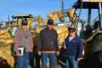 Buying equipment for their start-up construction business are (L-R) Sean Bratcher, Bobby Bratcher and Joe Becerra of Porterville, Calif. They were interested in this Cat 446B backhoe.
 