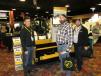 (L-R): Dono Rivas of Roadwidener shows brothers Dave and Rob Pagan of Martin Marietta, Denver, Colo., how this Roadwidener mounted to a S850 Bobcat skid steer works. Bobcat of the Rockies is a distributor of Roadwidener. 