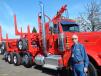 Dick Murphy, equipment sales of General Trailer Company, Springfield, Ore., poses with this Peterbilt truck and logging trailer combo. General supplied this trailer owned by Joel and Daren Olson of Olson Trucking, Vancouver, Wash.    