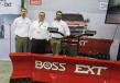 (L-R): Steve Grunlund, Mark Klossner and Jon Coyne, all of Boss Snowplow, present the BOSS EXT hydraulic controlled snowplow, which  is capable of expanding from 8 to 10 ft. (2.4 to 3 m) with an LED headlight as standard equipment.  