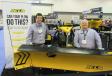 Tyler Jones (L) and Norm Klimko stand ready to answer questions about the many snow and ice control products in the Fisher Plows booth, including this XLS snowplow.
 
