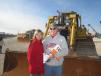 Traci and Eugene Montgomery look over this Cat D6R dozer.  