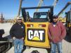 Tyson Wardlow (L) and Beau Shultz, both of Shultz Construction, enjoy the nice weather during the auction. 
 